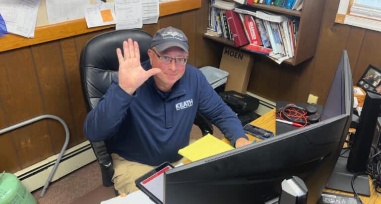 Keath employee waving from his desk