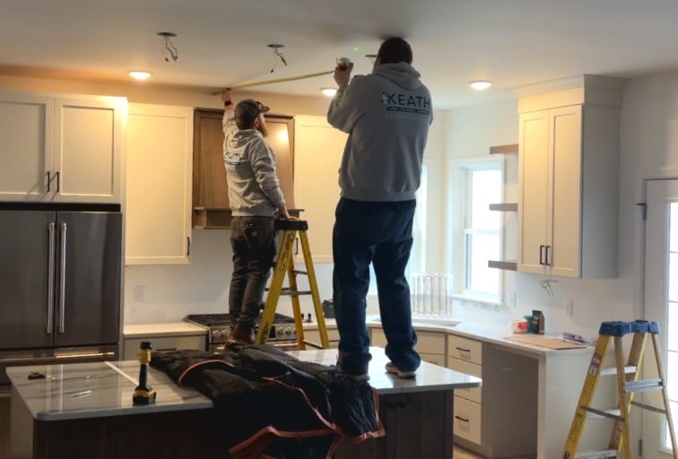 Keath electricians installing new lighting in a home's kitchen